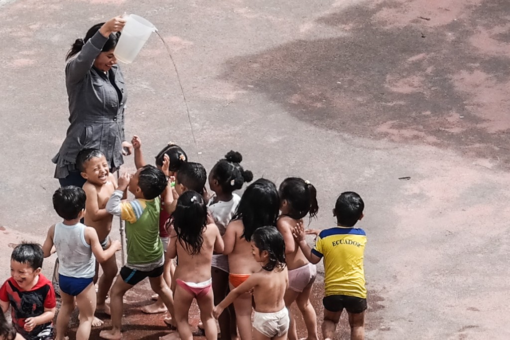 A simple pitcher of water bringing endless joy to these kids
