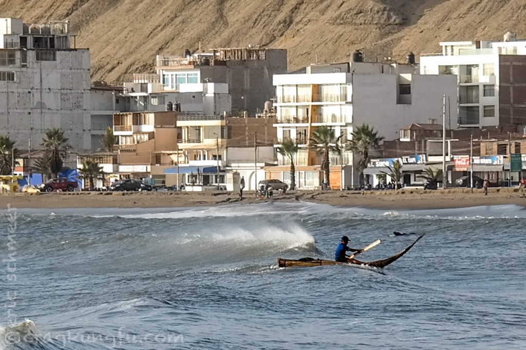 Fisherman surf the waves on their reed boats called caballitos de totora