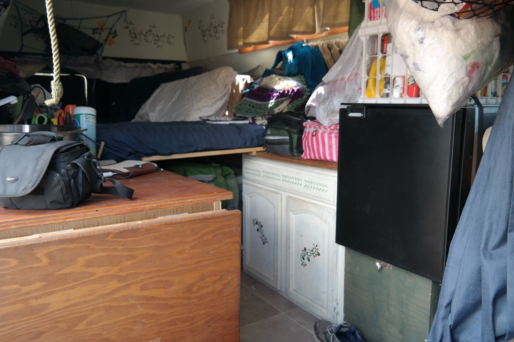 Kitchen area with bed in the background